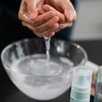 Woman washing her face with clean water