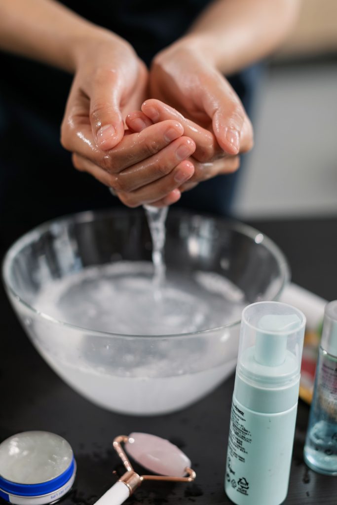 Woman washing her face with clean water